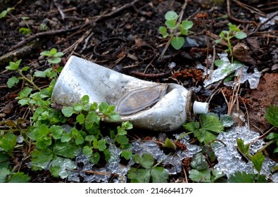 discarded waste in the forest lies in the bushes for many years. spray can still filled with freon gases. stroller wheels, home for the homeless. costly disposal of illegal municipal landfills