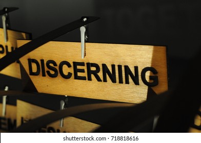 DISCERNING on a wooden sign, photograph Aspirations word - Shutterstock ID 718818616