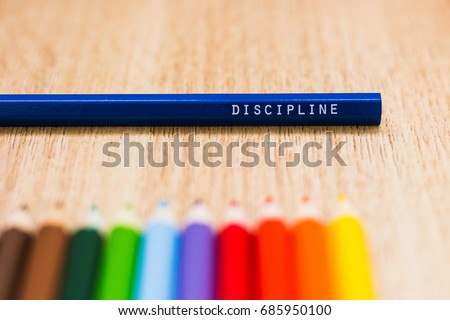 Discipline word written on a colored pencil. Education, school, discipline concepts
