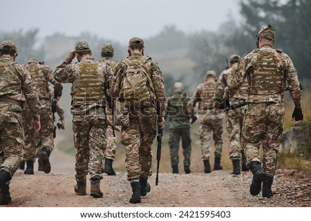 A disciplined and specialized military unit, donned in camouflage, strategically patrolling and maintaining control in a high-stakes environment, showcasing their precision, unity, and readiness for