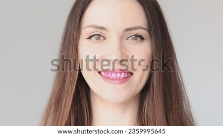 Disclosing tablets for dental plaque. Close-up of a woman's teeth. Pink tablet for detecting bacterial plaque