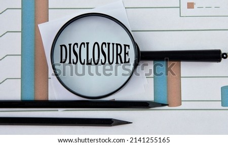 DISCLOSURE - word on a graph with pencils and a magnifying glass. Business concept