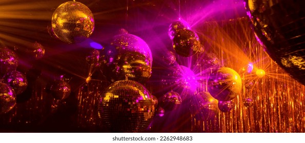 disco background with disco balls in purple and gold lighting - Shutterstock ID 2262948683