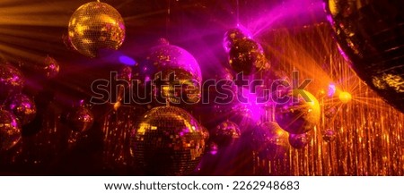disco background with disco balls in purple and gold lighting