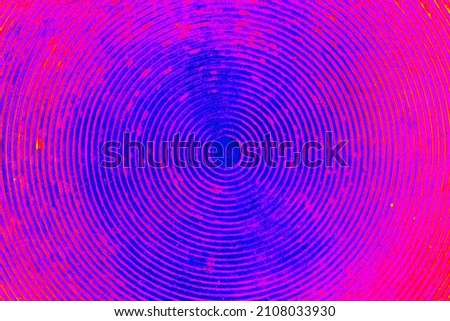 Disco background - concentric circles in fuchsia and blue color. Retro wallpaper.Textured background in the form of circles with a common center. 