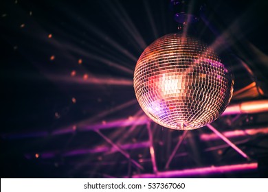 Disco ball with bright rays, night party background photo - Shutterstock ID 537367060