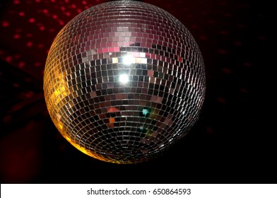 Disco ball with bright rays, night party background photo - Shutterstock ID 650864593