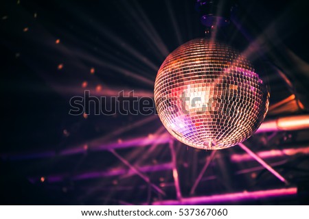 Disco ball with bright rays, night party background photo