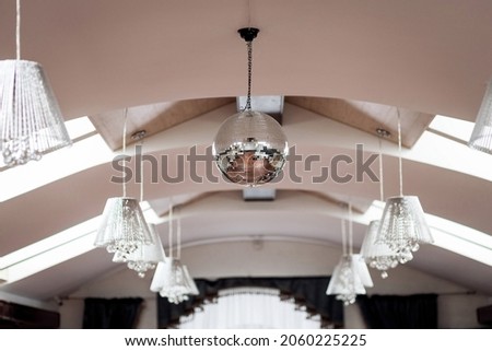 disco ball hanging on chainlet in disco club 