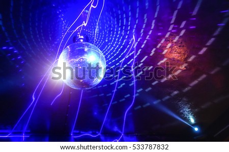 Disco ball laser show in modern party night club with bright spotlight - Concept of nightlife with music and entertainment - Image with powered colored halos and vivid glowing lights