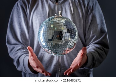 A Disco Ball Levitating Above A Man's Hand, Old School Party Concept