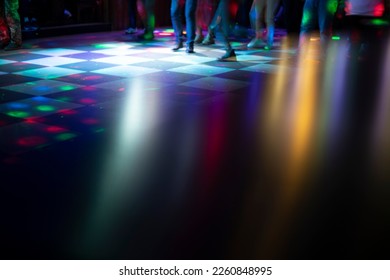 Disco in bar. Color music on dance floor. Bright colors in night club. Bright highlights from bright disco.