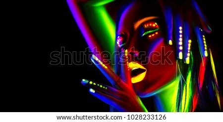 Disco dancer in neon light. Fashion model woman in neon light, portrait of beautiful model girl with fluorescent make-up, Body Art design in UV, painted face, colorful make up, over black background