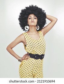 Disco Diva With Attitude. Cropped Shot Of Young Woman Wearing A 70s Retro Jumpsuit Striking A Pose In Studio.