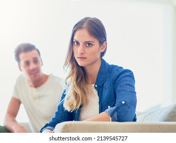 Disconnected. Portrait Of An Attractive Young Woman Giving Her Husband The Silent Treatment After A Fight.