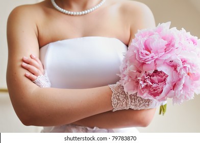 Discontented bride - young woman holding beautiful wedding flowers bouquet (peony)