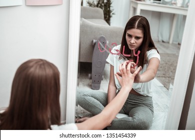 Discouraging. A young woman having low self-esteem and feeling ugly - Shutterstock ID 1351454339