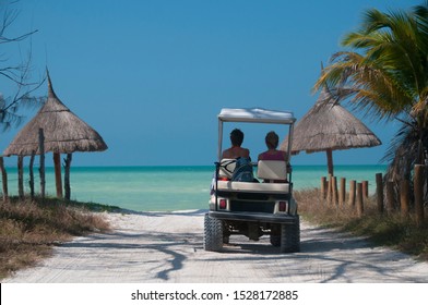 Discover the Caribbean island with a fun golf car in Mexico on the white sand paths on the sea shore, for a perfect holiday - Powered by Shutterstock