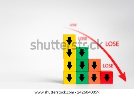 Discover the indicator of an economic crisis through a wooden block displaying a volume decrease icon and red arrow, symbolizing business deficit and financial downfall
