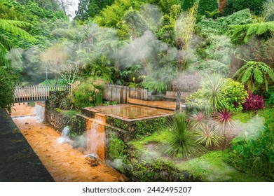 Discover the tranquil Poças da Dona Beija hot springs nestled in Sao Miguel lush landscapes, offering a serene wellness escape amid Azores volcanic nature. - Powered by Shutterstock