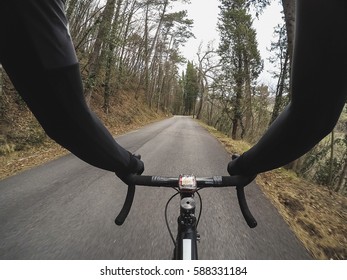 Discovering Tuscany On A Racing Bicycle. Pov. Personal Perspective Of A Cyclist Riding A Racing Bicycle On A Forest Road.