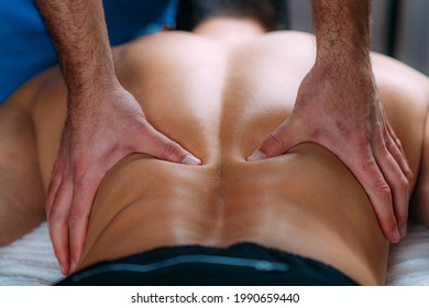 Discus Hernia manual massage treatment. Physical therapist massaging lower back. - Powered by Shutterstock