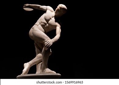 discus thrower ancient marble statue isolated on black background