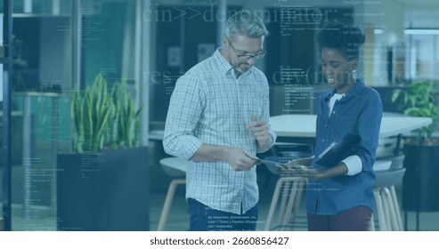 Discussing digital data two professionals pointing at tablet screen at open office, with folder. Collaboration, teamwork, innovation, modernity, professionalism, productivity, corporate