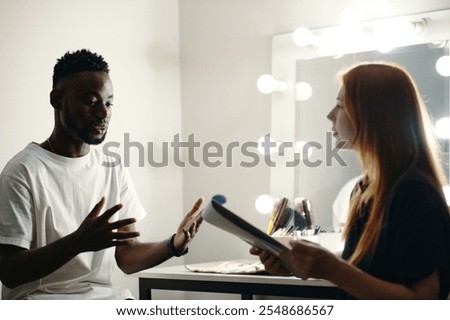 Discussing Performance Backstage with Crew Member Present