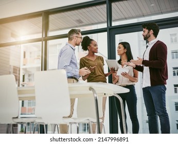 Discussing the status of business. Shot of a group of colleagues having a meeting in a modern office. - Shutterstock ID 2147996891