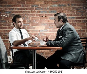 discussion in a coffee shop by two vintage businessmen - Powered by Shutterstock