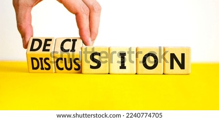 Discussion and decision symbol. Concept word Discussion and Decision on wooden cubes. Businessman hand. Beautiful yellow table white background. Business discussion and decision concept. Copy space.