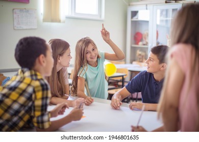 Discussion during class. Teenagers students sitting in the classroom and talking. Focus is on background.  - Shutterstock ID 1946801635