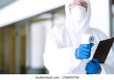 Disease control expert with an Infrared thermometer equipment to check the temperature at office. The concept of preventing the spread of the epidemic and treating coronavirus, pandemic in quarantine  - Shutterstock ID 1766955746