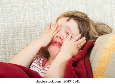 Diseased girl lying under a blanket at home  - Powered by Shutterstock
