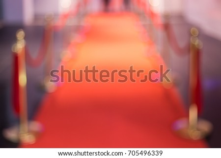 Disfocus of the red carpet between rope barriers in the success party