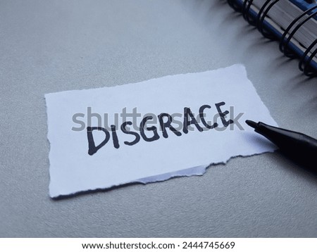Disgrace writting on table background.