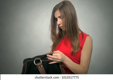 Disgruntled Girl Forgot Her Wallet With The Money At Home. Not Enough Money For Shopping. The Lost Wallet Concept.