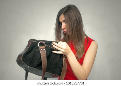 Disgruntled Girl Forgot Her Wallet With The Money At Home. Not Enough Money For Shopping. The Lost Wallet Concept.