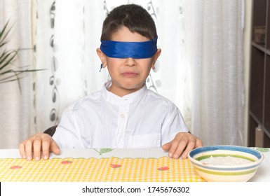 Disgust Gesture On The Face Of An 8-year-old Boy After Having Done A Food Taste Test.