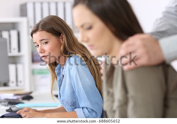 Disgusted employee being victim of harassment and a\
colleague watching\
her
