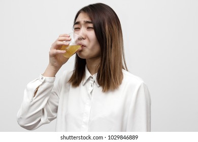 Disgusted Woman Drinking Apple Juice With Bad Taste. Not Tasty Beverages Concept