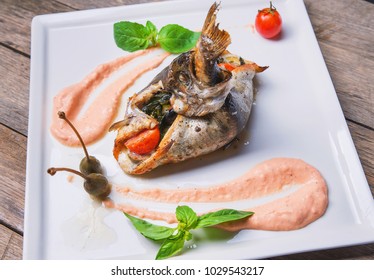 A Dish Of Baked Flounder Stuffed With Vegetables