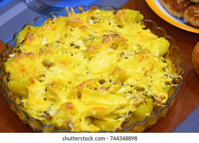 dish with baked potatoes over cheese