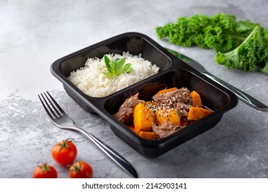 a dish in a black disposable container from catering on a concrete background, dietary catering, ready meals with you, healthy food - Shutterstock ID 2142903141