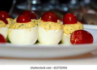 Dish Of Boiled Stuffed Eggs. Boiled Egg Decorating Idea Tomatoes. The Design Of The Food For The Table. 