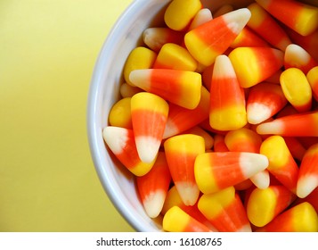 Dish Of Candy Corn On Yellow Background