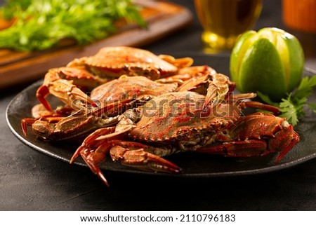 Dish of cooked crabs on the table.