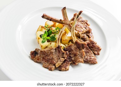 Dish With Lamb Chops And Roast Potatoes On White Background