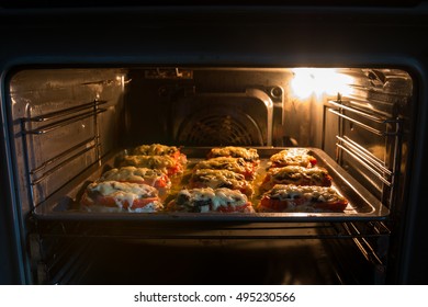 a dish of meat, cheese and dough and vegetables are prepared in the oven - Shutterstock ID 495230566